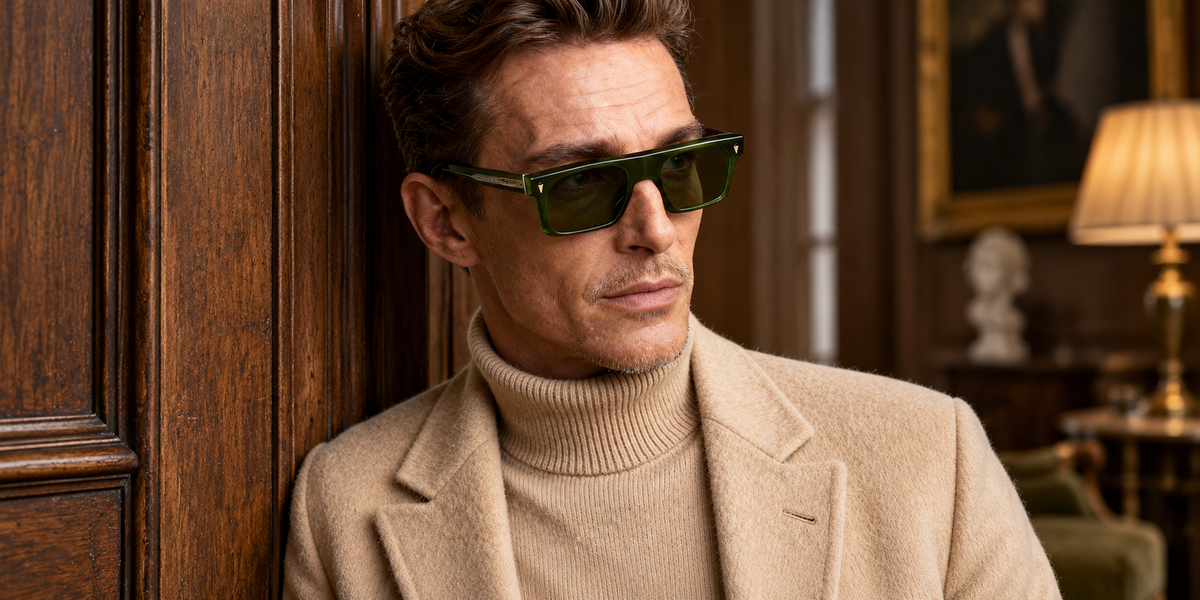 Man wearing green rectangular sunglasses in a warm wood interior
